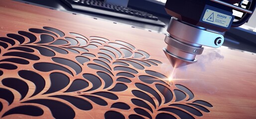 Fototapeta Laser cutter close up, cutting flower patterns on a wooden board.  obraz