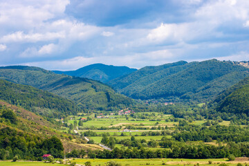 Fototapeta na wymiar landscape with a rural area between the hills