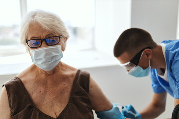Fototapeta na wymiar elderly woman vaccination in hospital coronavirus pandemic covid-19