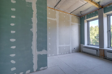 empty white green drywall room with repair and without furniture