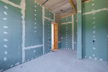 empty white green drywall room with repair and without furniture