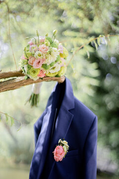 
Wedding. The groom's jacket on the street. Groom's jacket and bridal bouquet