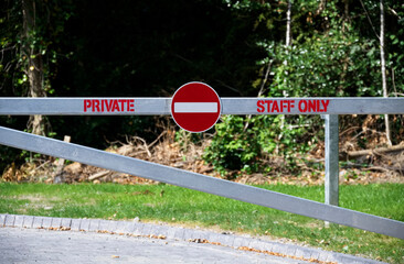 Staff entrance sign on private gate at workplace