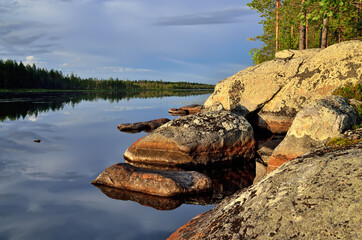 Northern Karelia, Russia. Rocky shore of Lake Pongoma on a sunny summer evening,