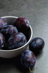 Fresh plums. Fruits. On a dark background. Copy space.