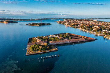 Flying over small Venice islands located in the middle of the Venetian lagoon. Beautiful aerial view of Venice.