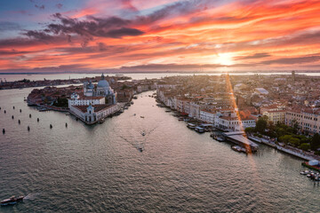 Naklejka premium Magical evening sunset view over beautiful Venice in Italy. Aerial view of the Venice lagoon with a beautiful city view.