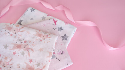 Set of cute napkins cloth for newborn girl with bow on gently pink background. Bright accessories for baby. Birthday, childcare and maternity concept