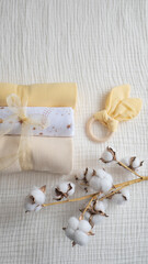 Baby set of yellow cloth diaper with wooden toy and pampas grass. Gender neutral newborn...