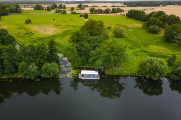 Fototapeta premium aerial view of houseboat in the river
