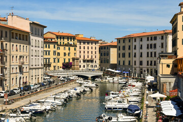Fototapeta na wymiar High-angle view of the canal harbour of the New Venice district with docked boats in summer, Livorno, Tuscany, Italy