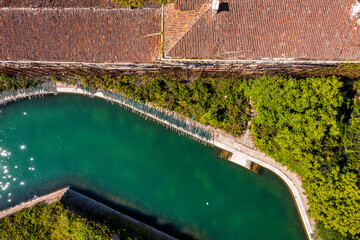 Aerial view of the plagued ghost island of Poveglia in the Venetian lagoon, opposite Malamocco along the Canal Orfano near Venice, Italy.