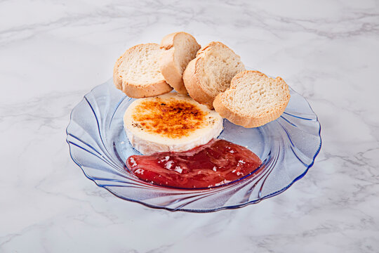 rulo de queso de cabra a la parilla con mermelada de frambuesa y pan tostado