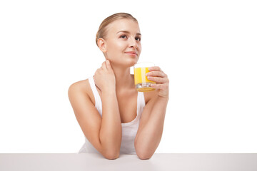 Young woman with a glass of orange juice isolated