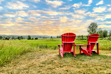 Adirondack chairs positioned to take in the view of a valley