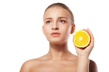 Young beautiful woman with orange over white