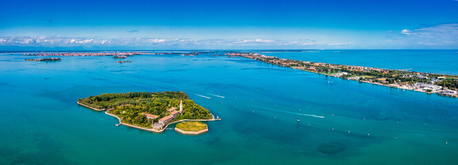 Aerial view of the plagued ghost island of Poveglia in the Venetian lagoon, opposite Malamocco along the Canal Orfano near Venice, Italy. © Aerial Film Studio