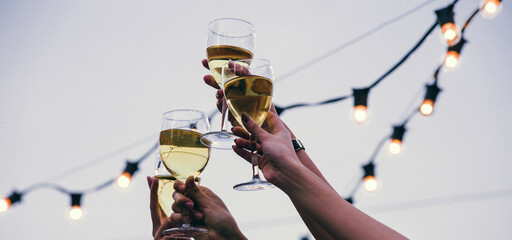 Celebration in hand holding champagne glasses and saying cheers It represents happiness, fun, success, and unity. - obrazy, fototapety, plakaty