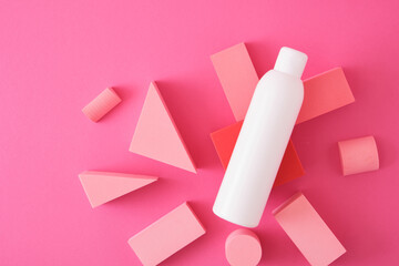 white mock up bottle with shampoo or shower gel and geometric shapes forms.