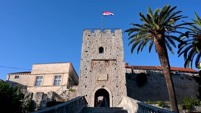 Old stone gate in Historic town of Korcula, Croatia.Tower Revelin or Land gate. Entrance in old town. Walls and towers in old castle. 