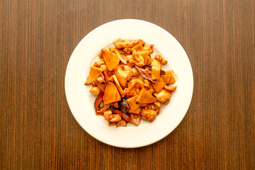 Top view image of popular Asian recipe for chicken with bamboo and Chinese mushrooms with sauteed vegetables and soy sauce