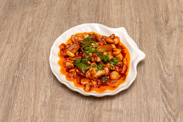 Vegan seitan recipe simulating chicken meat with sautéed vegetables and nuts