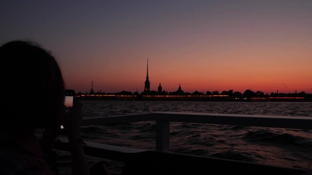 Iconic silhouette of the Peter and Paul Fortress in Saint Petersburg as seen from tour boat on the Neva river. Russia