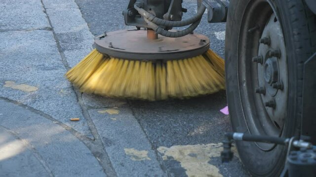 A street sweeper cleaning a street.