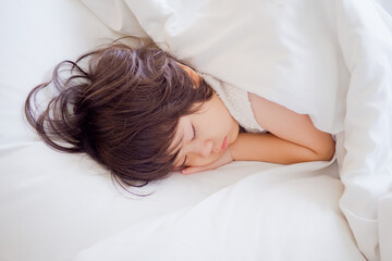 Fototapeta na wymiar asian kid sleep on bed, sick child 