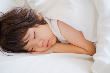 Fototapeta na wymiar asian kid sleep on bed, sick child 