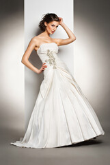 Fototapeta premium The beautiful young woman in a wedding dress