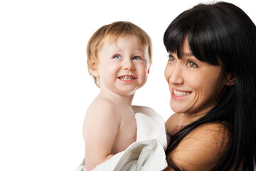 Young mother with her baby after bathing in a white towel