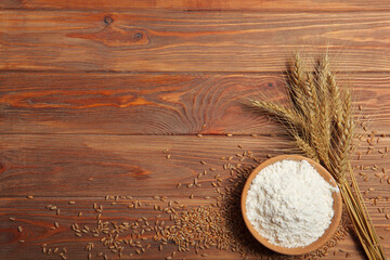 Wheat flour and spikelets of wheat on a light background