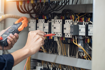 Electrician engineer work tester measuring voltage and current of power electric line in electrical...