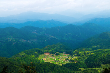 Fototapeta na wymiar Chinese mountain village with blues mountains as the background.
