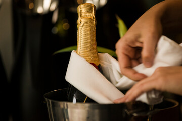 woman holding bottle of red wine and glass