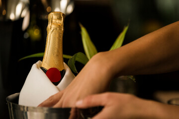 woman holding bottle of red wine and glass