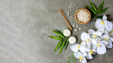 Relax Thai Spa.  Massage spa and hot stones setting for treatment and relax with white orchid on blackboard.  Lifestyle Healthy Concept,  copy space for banner