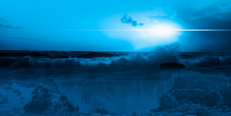 Night sky with blue moon in the clouds with stormy sea wave