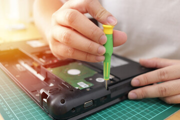 Close up of technician engineer trying to repairing broken laptop. Computer repairs and upgrade