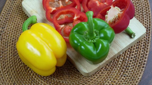 Sweet Bell pepper on Wooden background, Top view Rotate Sweet red green yellow pepper on Wooden background, 4k resolution.