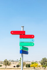 Blank signpost with many directions against blue sky in sunny day. Mockup. copy space.