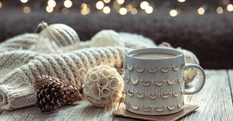 Close up of Christmas cup and winter decor details on blurred background.