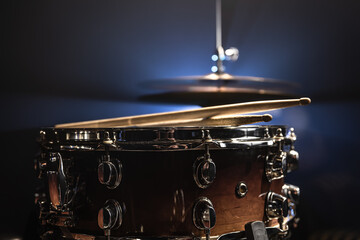 Fototapeta na wymiar Part of a drum kit, snare drum on a dark background.