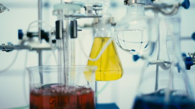Chemical laboratory with flasks and test tubes. Chemical process with boiling of a chemical solution and synthesis of organic matter
