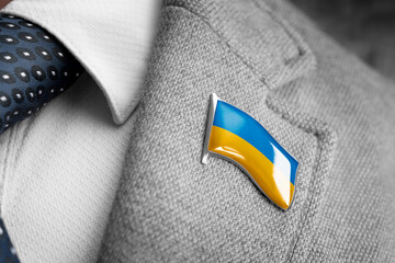 Metal badge with the flag of Ukraine on a suit lapel