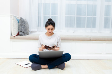 Asian young woman holding credit card and using laptop. Online shopping concept