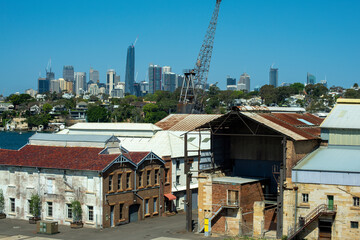 Fototapeta premium View of city skyline with industrial buildings in foreground, Sydney, NSW, Australia