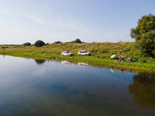 people resting at the river beach. car travel concept