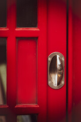 Detail of door old red UK Telephone  box with chrome handle